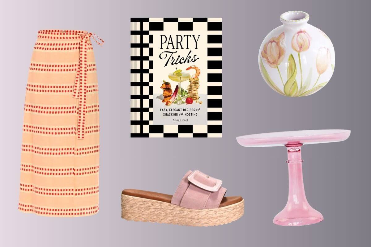 A pink-striped wrap skirt, Birmingham FINDS April’s cookbook "Party Tricks," a white vase with tulip design, a pink glass cake stand, and a pink platform sandal are displayed on a gradient background.