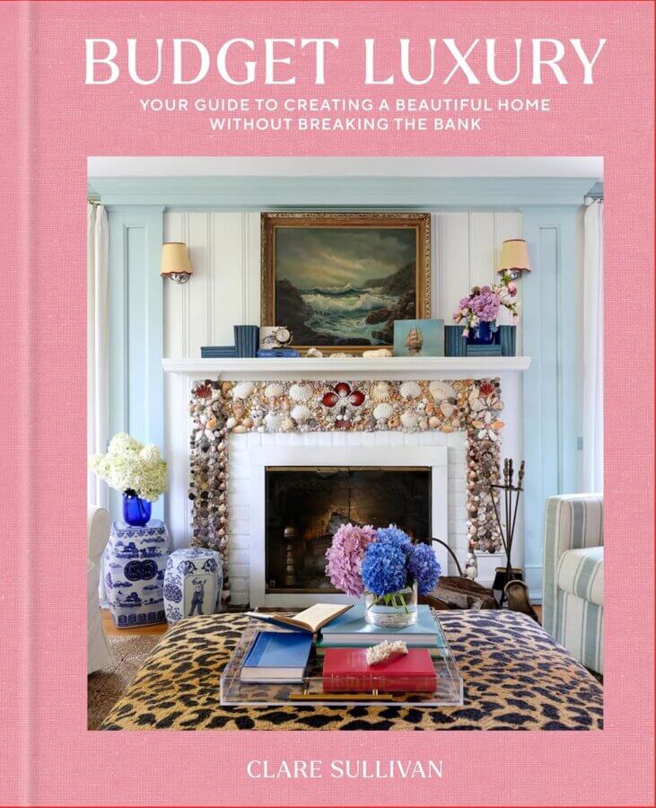 9 New Design-Forward Coffee Table Books for Your Wish List - 6 The cover of a 2026 design book, pink with an image of a fireplacethat boasts seashell inlays. The book is by Clare Sullivan.
