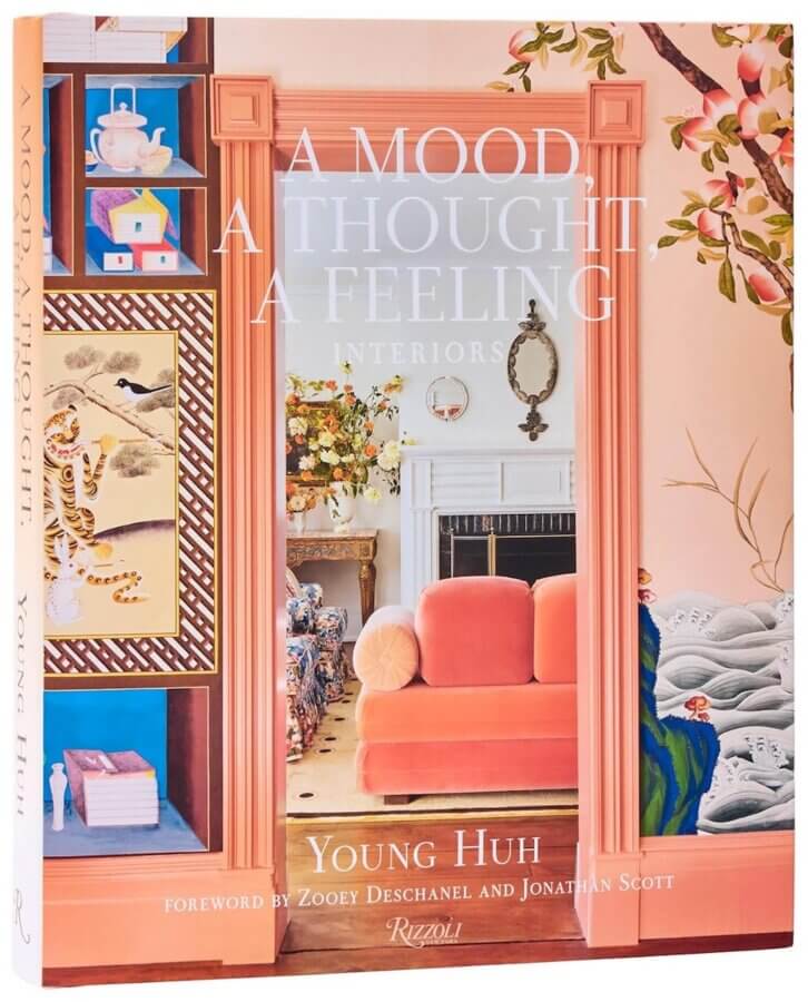 9 New Design-Forward Coffee Table Books for Your Wish List - 4 The cover of "A Mood, A Thought, A Feeling: Interiors" by Young Huh inspires design envy with its peach-colored doorway, elegant fireplace, and patterned wallpaper—an anticipated 2026 coffee table book among upcoming book releases.