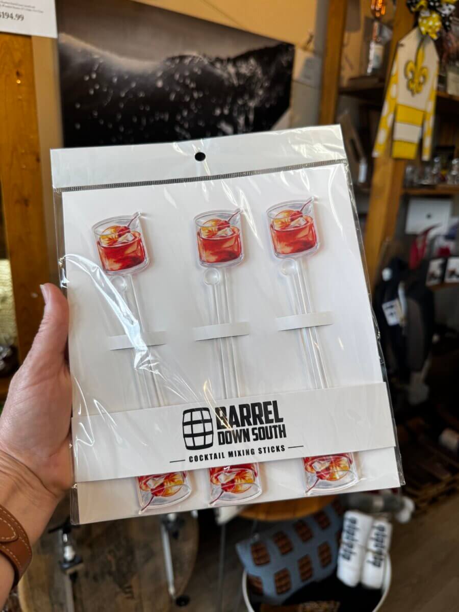 15 Louisville FINDS for May: Spring Fashion, Entertaining Essentials & More - 11 A hand holds a package of "Barrel Down South" cocktail mixing sticks with images of a cocktail on top, found in a Louisville storeβperfect for May FINDS.