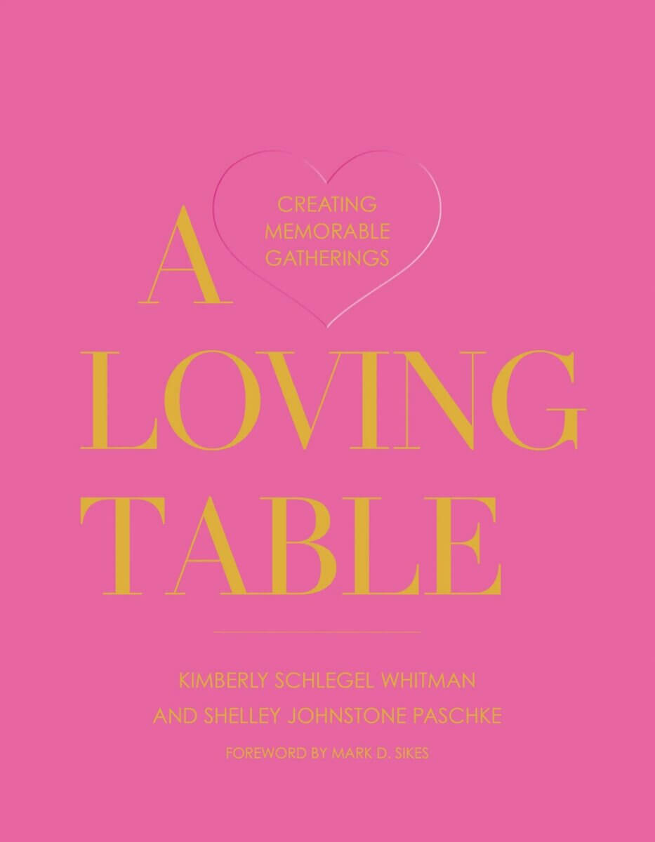20 Spring FINDS for Mother’s Day & Beyond: Style, Beauty & Home Must-Haves - 15 Pink book cover with the title "A Loving Table" in large yellow text and a heart outline. Authors: Kimberly Schlegel Whitman and Shelley Johnstone Paschke. Perfect for Nashville style inspiration, featured in FINDS Draft May 2026.
