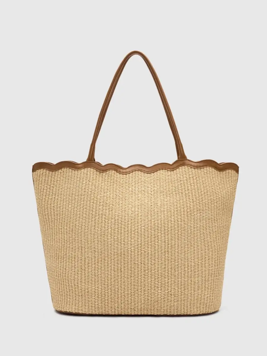 4 Easy, Breezy Fashion Trends for Summer 2026 - 3 A woven tote bag with brown leather handles and a scalloped leather trim along the top edge, capturing the essence of 2026 Summer Trends, set against a plain white background.