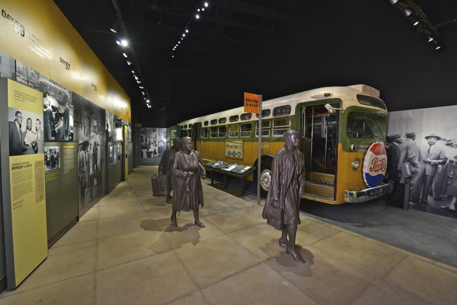 Living History: 7 Tennessee Towns Where the Past Comes Alive - 14 Exhibit featuring a vintage bus, informational panels, historical photos, and bronze statues of people, illustrating a scene from the civil rights era in one of America’s historic towns.