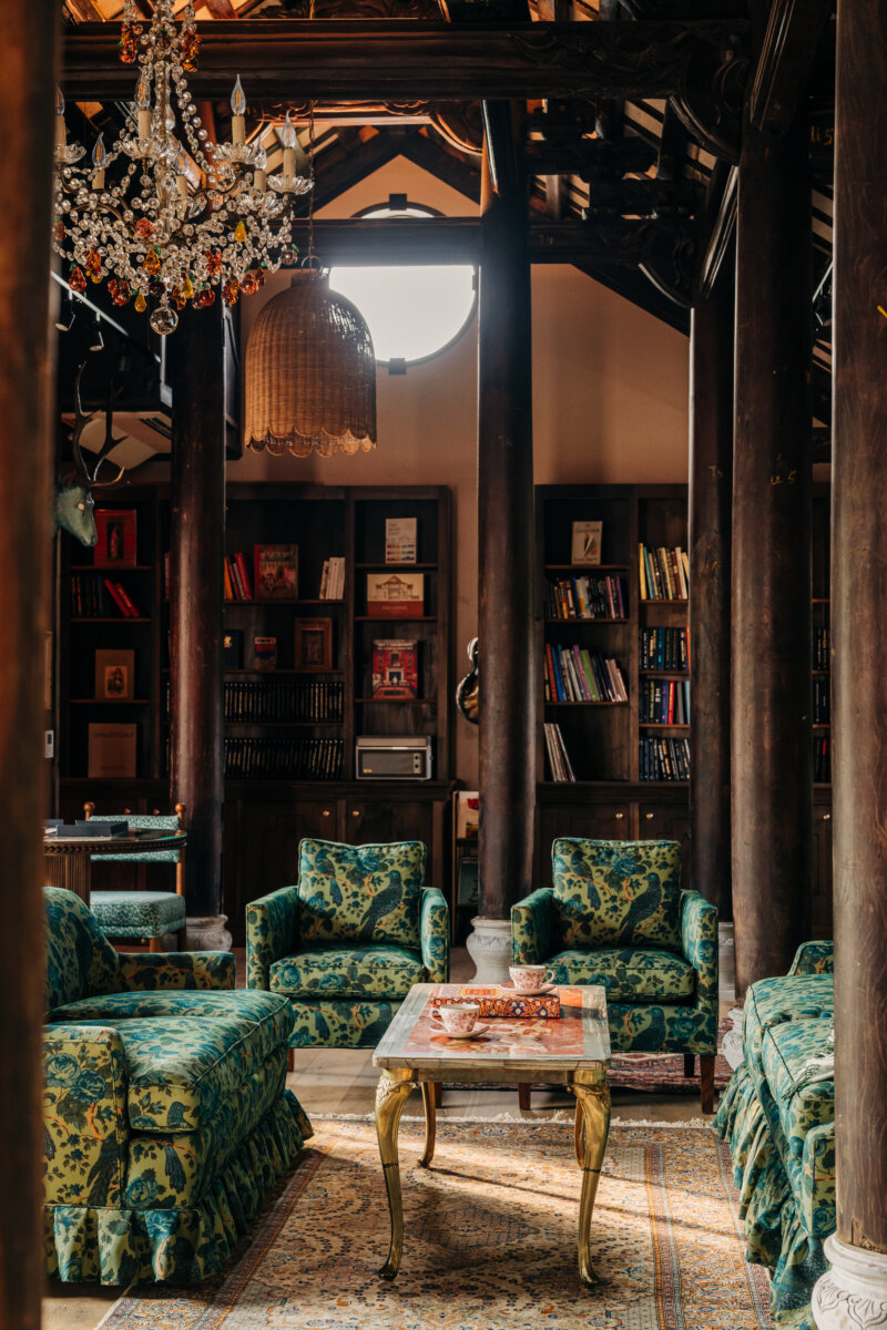She's Behind Camp Lucy, a Dreamy Austin-Area Escape - 11 Interior of the library at Camp Lucy, with plush green chairs.