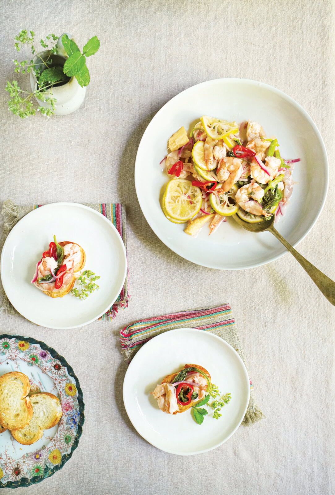 3 Cool, Crisp Recipes from the 'Down South + East' Cookbook - 2 Various white plates with servings of shrimp.