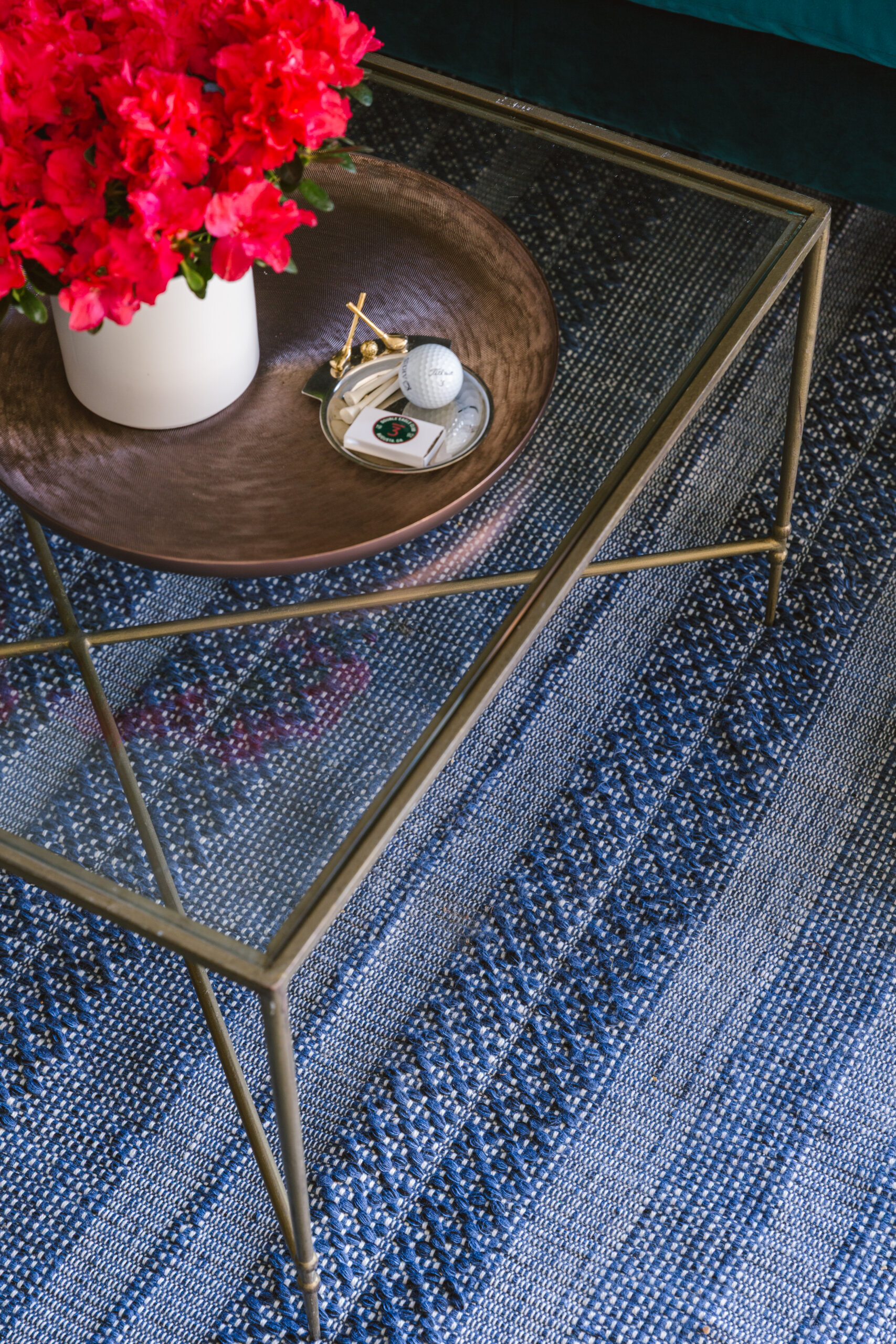 A Masters-Inspired Design Project You Need to See - 9 A glass table boasts a floral arrangement and a golf-themed dish.