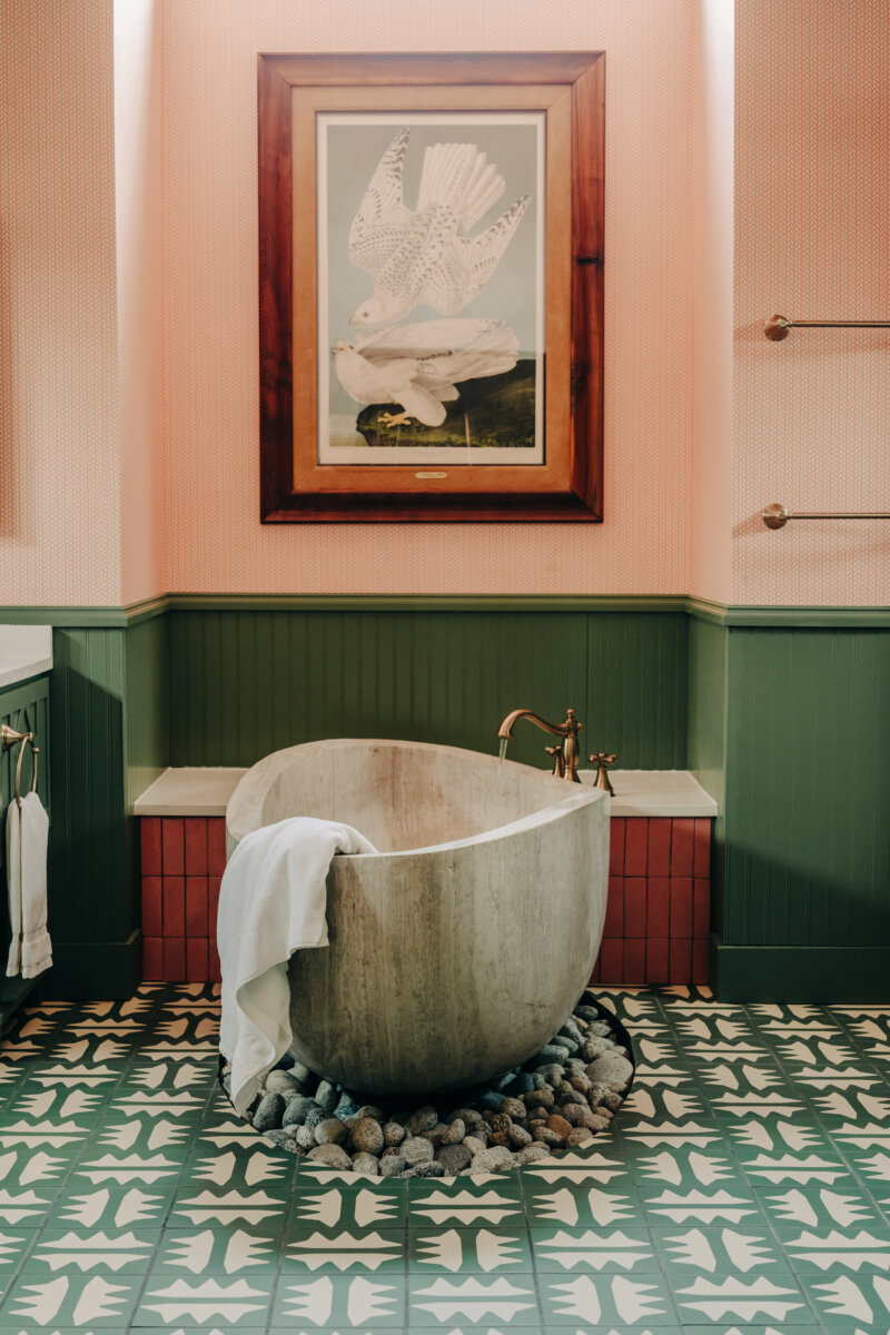 She's Behind Camp Lucy, a Dreamy Austin-Area Escape - 9 An earthy soaking tub in a bathroom with green, patterned tile.