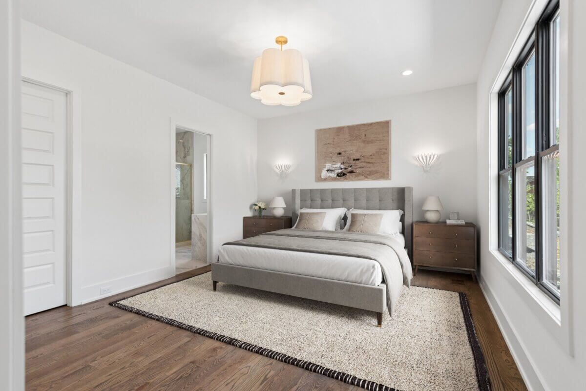 Modern bedroom at 508 Stonewall Way with a gray upholstered bed, two wooden nightstands, neutral decor, large windows, and a beige area rug over hardwood floors in desirable Brentwood TN.