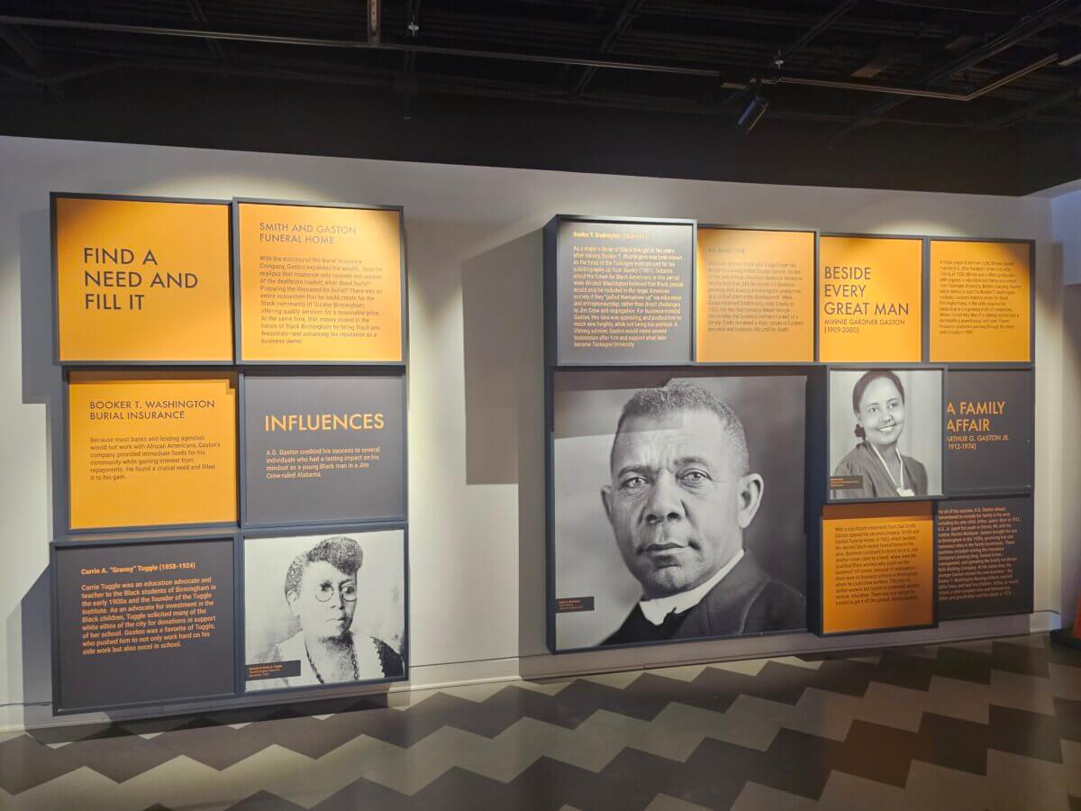 How Two BHAM Creatives Built a Coffee Shop Centered on Connection - 9 A.G. Gaston exhibit wall featuring biographical panels, quotes, and large photos of Booker T. Washington and other figures, highlighting funeral home history and influential individuals.