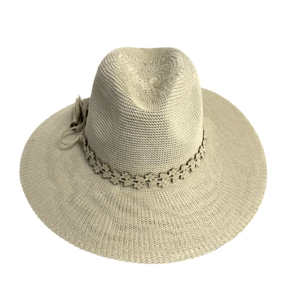 Beige woven sun hat with a wide brim, perfect for May in Nashville. Features a decorative band with a floral pattern and a tassel on one side—one of our latest FINDS.