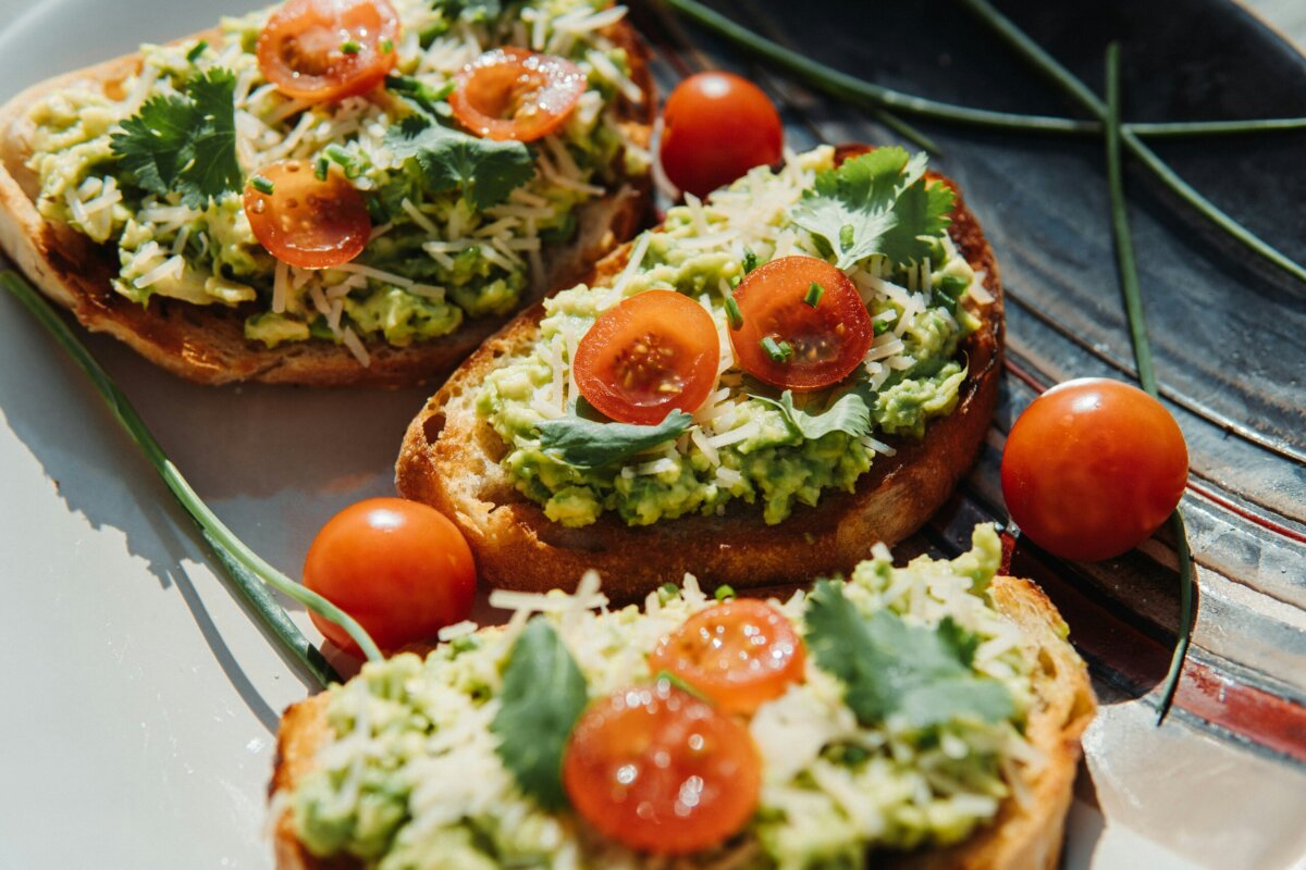 You Don't Need a Cleanse ... You Need More Fiber. - 2 Avocado toast, featuring cherry tomatoes, on a plate.