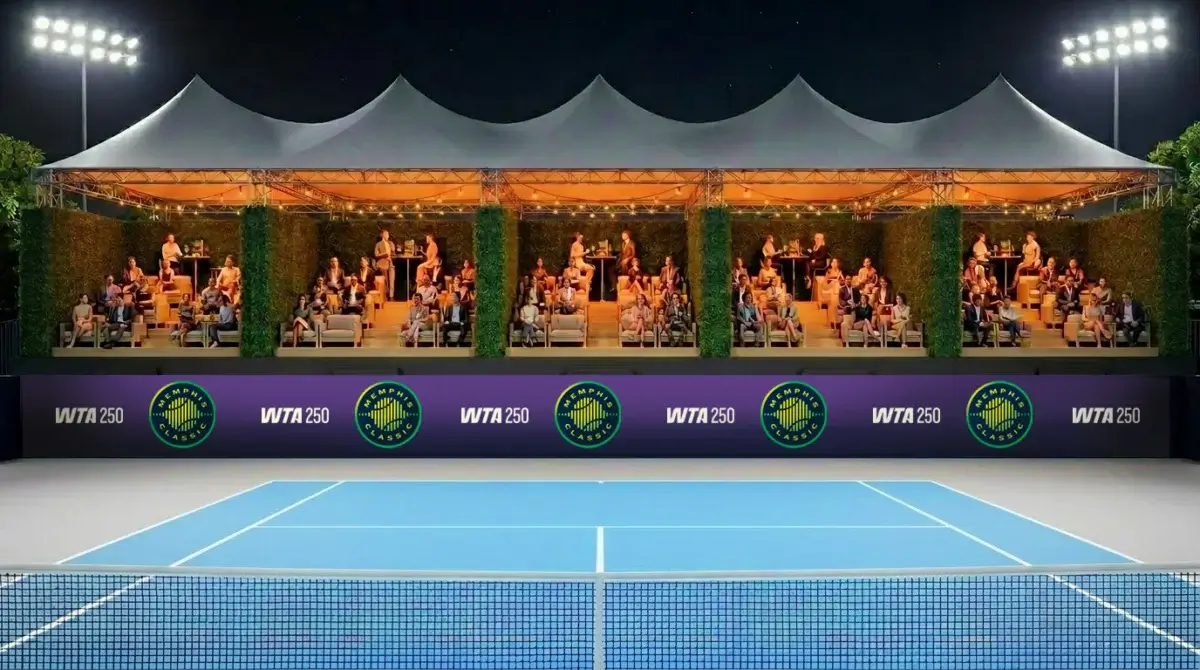 The Memphis Classic: The Return of Professional Women’s Tennis to Bluff City - 4 Spectators sit in a covered, lit grandstand watching a tennis match on a blue court at night, with WTA 250 banners displayed along the back wall.