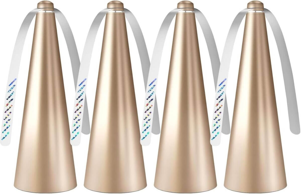 Four gold metallic cone-shaped party blowers with white mouthpieces and ribbons stand upright in a row against a white background.
