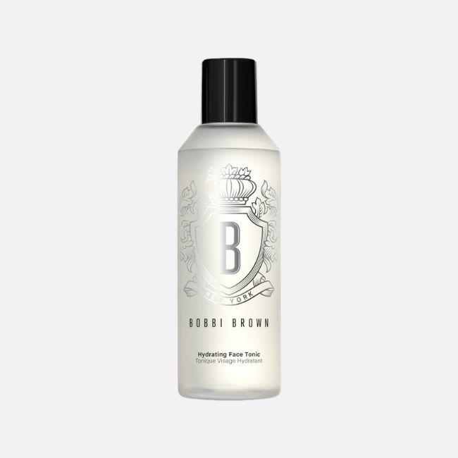 A clear bottle of Bobbi Brown Hydrating Face Tonic with a black cap and decorative label, set against a plain white background—perfect for refreshing your skin as part of your summer makeup tips routine.