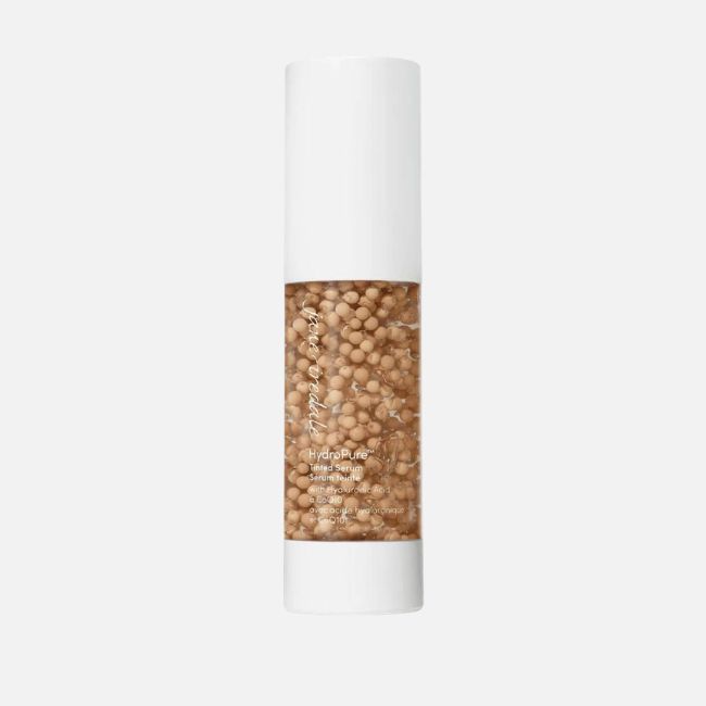 A cylindrical bottle with a white cap and base, containing a visible brown gel with suspended beads, labeled "HydroPure" on the front—perfect for refreshing your look and essential in summer makeup tips.