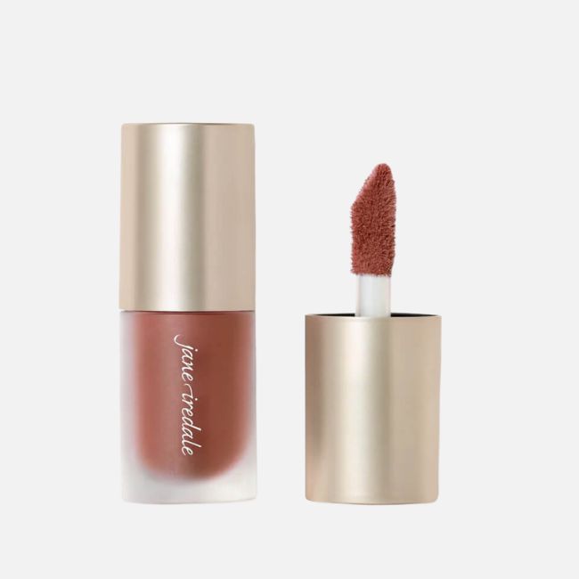 A tube of Jane Iredale liquid lipstick with the cap removed, showing a doe-foot applicator covered in brownish-pink lip color—perfect for effortless summer makeup tips.