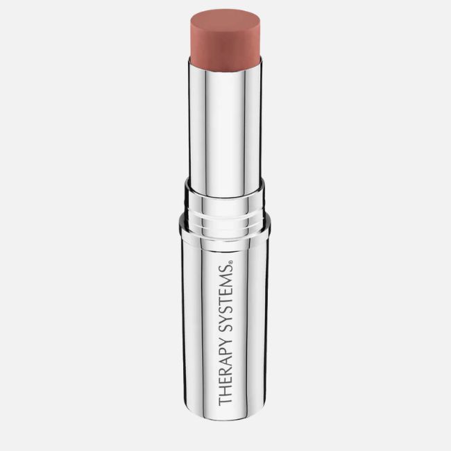 A silver tube of Therapy Systems lipstick with a nude pink shade exposed, perfect for effortless beauty and glowing summer makeup tips.