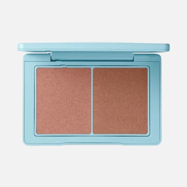 A blue makeup compact with two side-by-side brown powder pans, displayed open on a white background—perfect for achieving a flawless look with your favorite summer makeup tips.