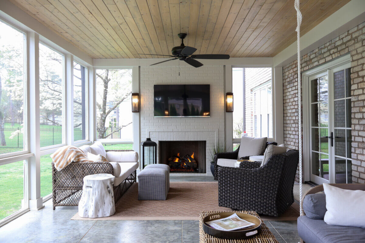 10 Designer Tips for Upgrading Your Outdoor Spaces - 12 An outdoor living room with a fireplace flanked by wall sconces.