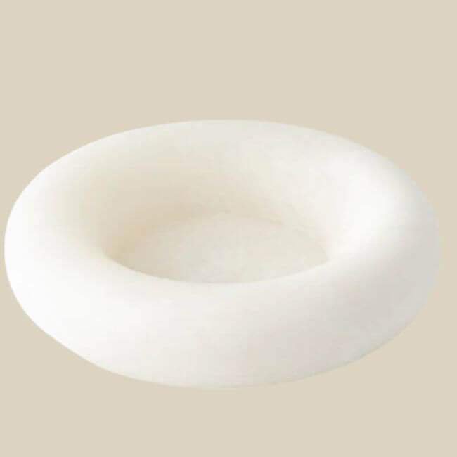 17 Luxurious Birmingham FINDS: Polished Summer Style, Artful Decor & Everyday Luxuries - 10 A round, white, shallow dish with smooth edges evokes a luxurious summer vibe, set against a plain beige background—reminiscent of chic Birmingham interiors.
