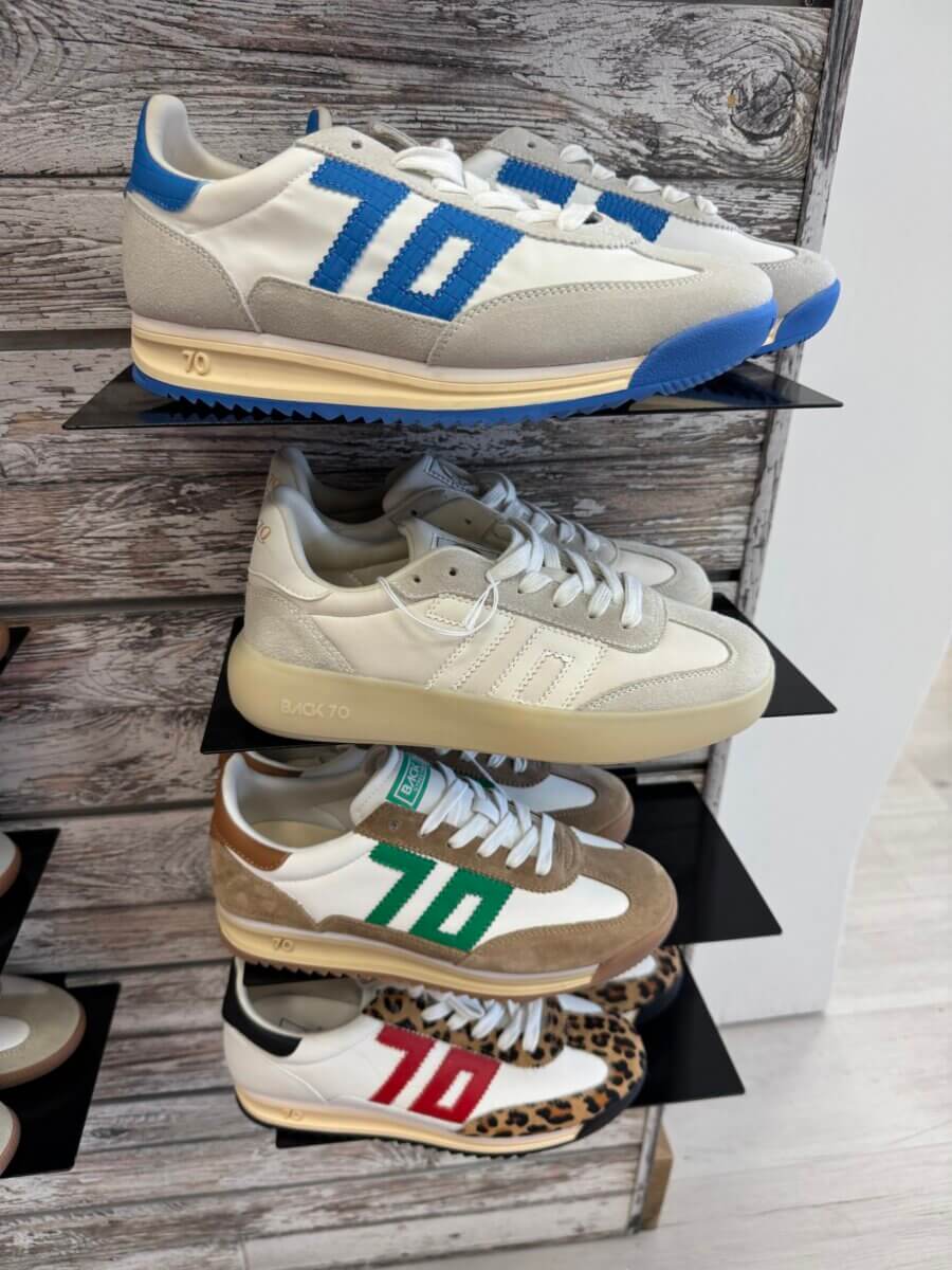 16 Louisville FINDS for June: Summer Style, Tabletop Charm & Little Luxuries - 3 Four pairs of retro-style sneakers on display shelves—each pair sporting a bold "70" in blue, cream, green, or red—make standout summer picks for June in Louisville, with unique sole and upper color combinations.