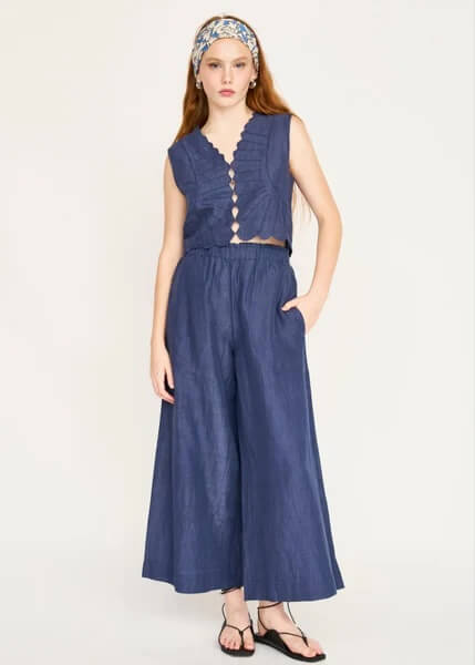 15 Memphis FINDS to Kick Off Summer: Vacation-Ready Style & More - 9 A woman wears a sleeveless blue buttoned top with wide-leg matching pants, a patterned headband, and black sandals—an effortlessly chic look that’s perfect for those searching for unique Mother's Day gift ideas.