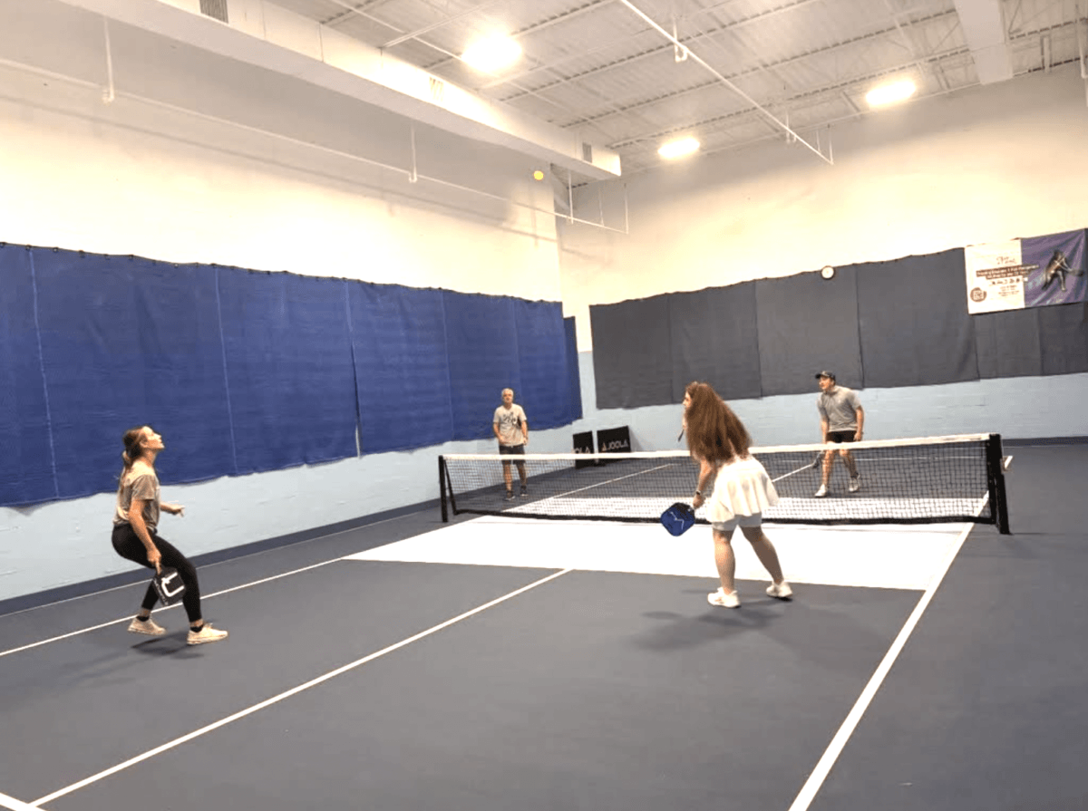 11 Places to Play Pickleball in Memphis - 2 People playing pickleball on an indoor court in Memphis.