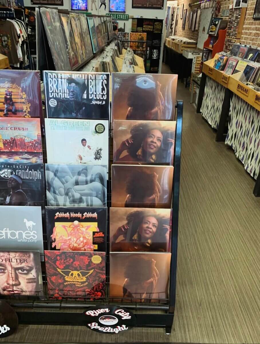 Your Updated Guide to South Main: A Hot Spot with Rich History - 6 Vinyl records displayed on racks in a record store, featuring various album covers, including multiple copies of an album with a woman smiling.