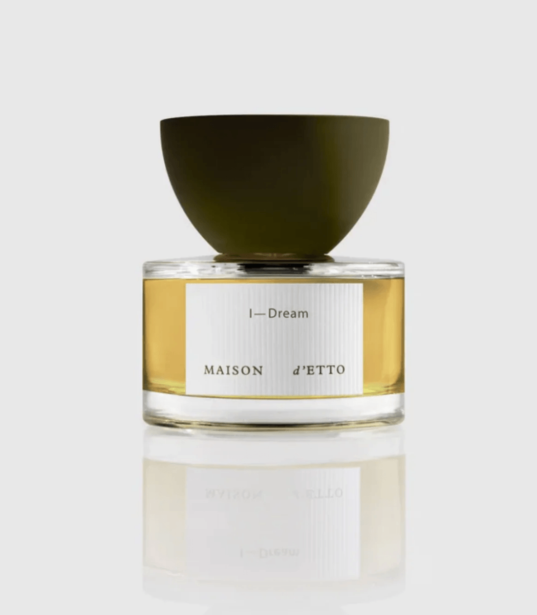 18 Nashville Luxe Loves: Statement Jewelry, Custom Hats & Summer Showstoppers - 14 A clear glass perfume bottle labeled "Maison d'ETTO I-Dream" with a wide dark green cap exudes luxe elegance, set against a plain white background.
