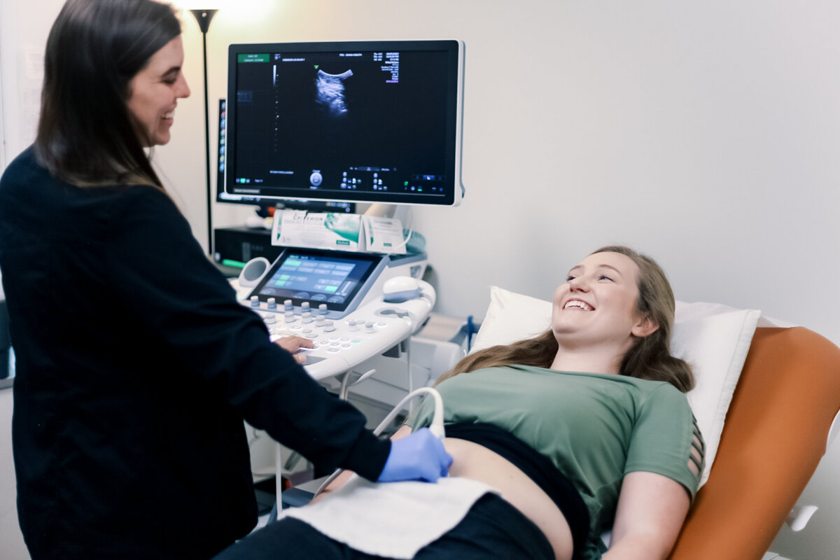 Beyond Birth: Why Women Are Choosing Midwives for Everyday Care - 2 A nurse checks a woman's belly with ultrasound equipment.