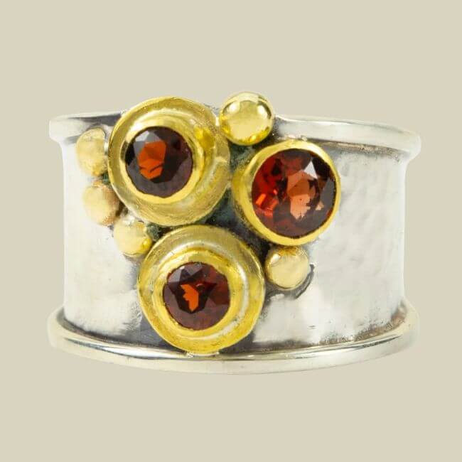 Nashville Steals, Deals & Announcements: July 2026 - 5 Wide silver ring with three round red gemstones set in gold bezels and small gold accents—a striking piece.