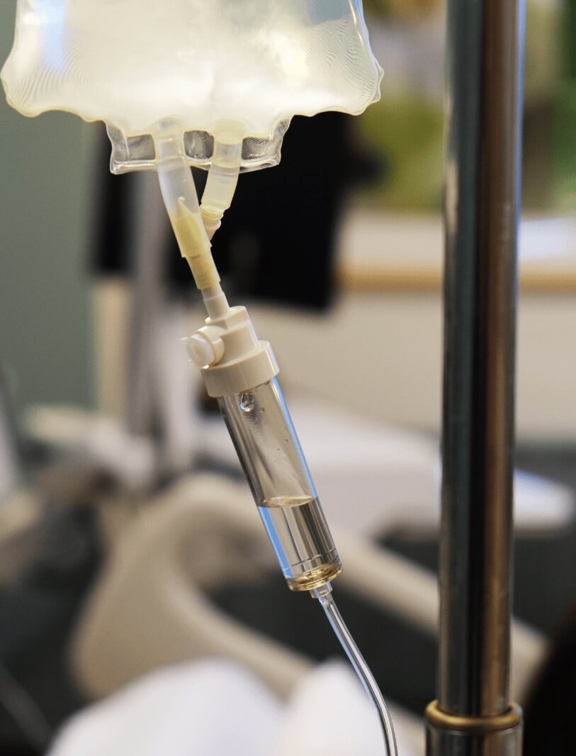 Nashville Steals, Deals & Announcements: July 2026 - 3 Close-up of an intravenous (IV) drip chamber attached to a fluid bag, set against a blurred hospital or medical setting—capturing a vital moment as Nashville announcements impact the local healthcare scene.