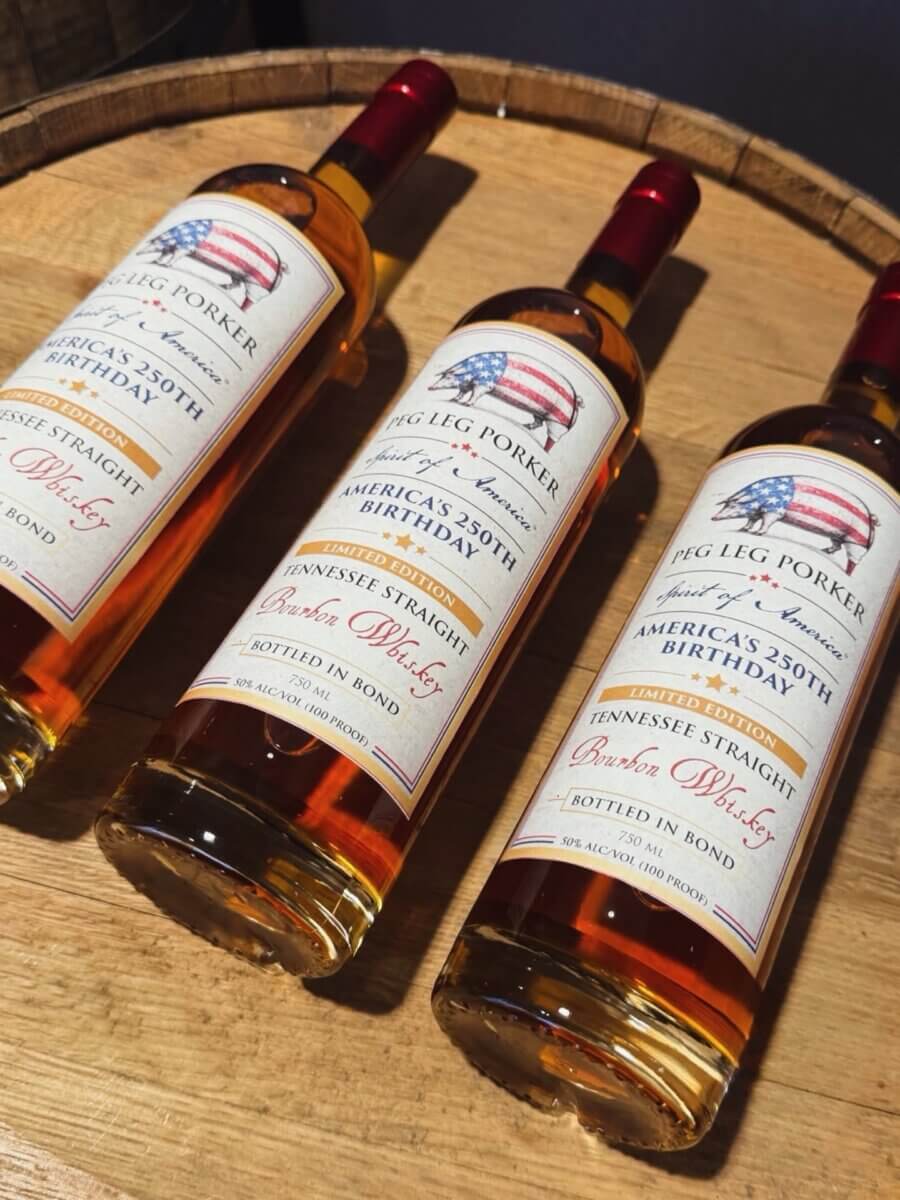 Nashville Steals, Deals & Announcements: July 2026 - 10 Three bottles of Pig Leg Porker Tennessee Straight Bourbon Whiskey, labeled for America’s 250th birthday, rest on a wooden barrel—one of the latest Nashville Steals perfect for collectors and whiskey enthusiasts.
