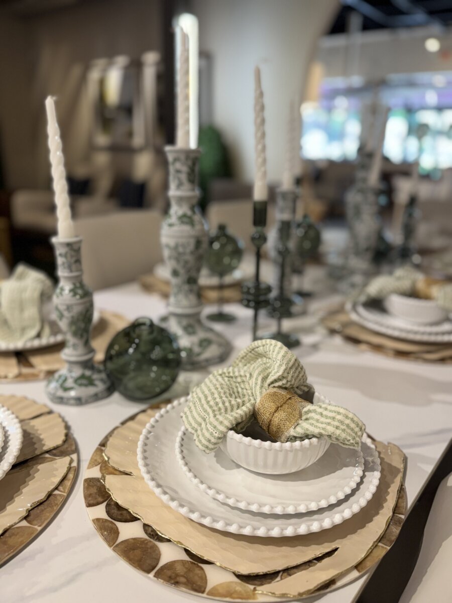 How to Refresh Your Porch in One Weekend, According to the Experts - 3 A formal dining table set with white beaded plates, woven placemats, green glass accents, candlesticks, and textured napkins arranged in bowls inspires elegant porch decor ideas.