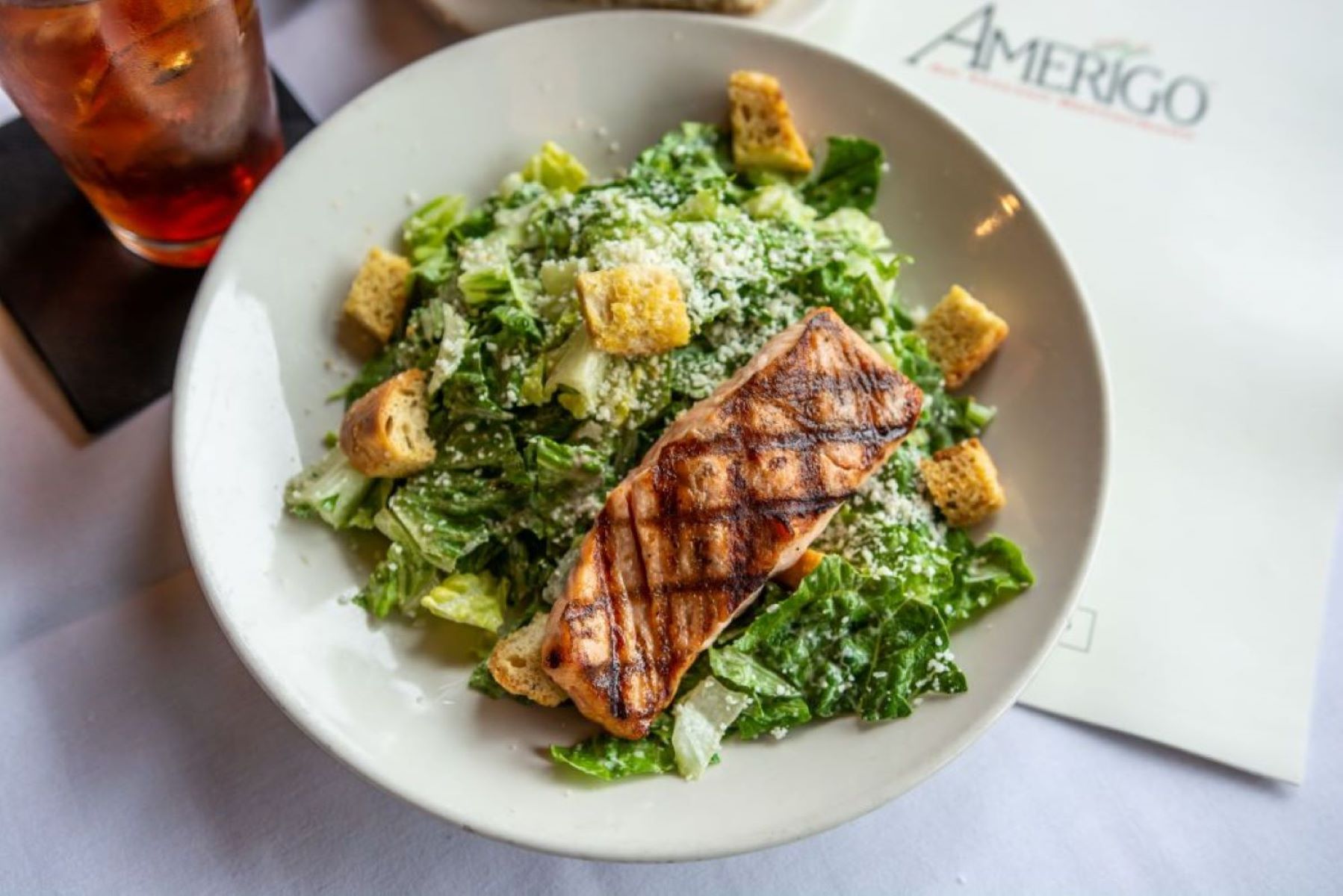 Grilled salmon served on a Caesar salad with romaine lettuce, croutons, and shredded parmesan cheese—a fresh favorite at one of the best lunch spots Nashville has to offer.