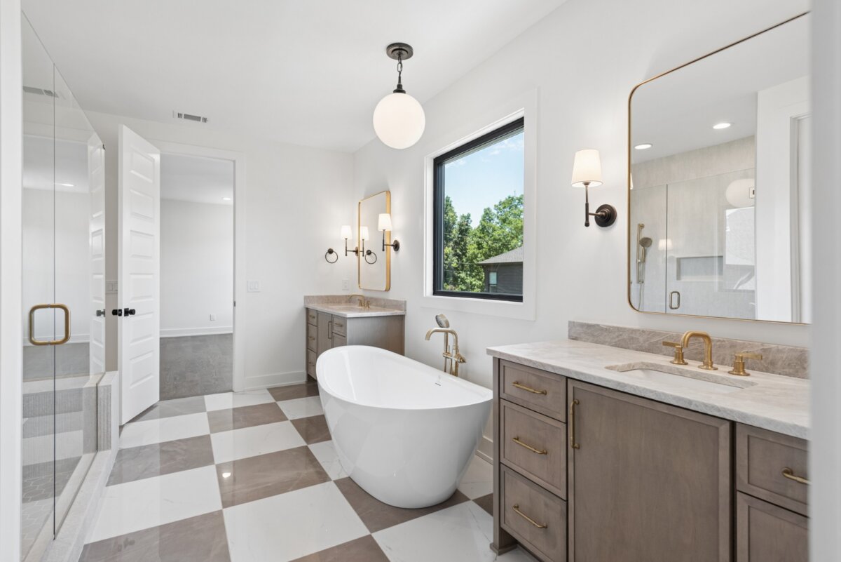 510 Stonewall Way, Brentwood TN - 5 Experience luxury living in this modern Brentwood TN bathroom, featuring a freestanding tub, spacious walk-in shower, double vanities with gold fixtures, expansive mirrors, and an elegant checkered tile floor—one of the many stunning features found at 510 Stonewall Way. Perfectly representing the sophistication of Brentwood real estate.