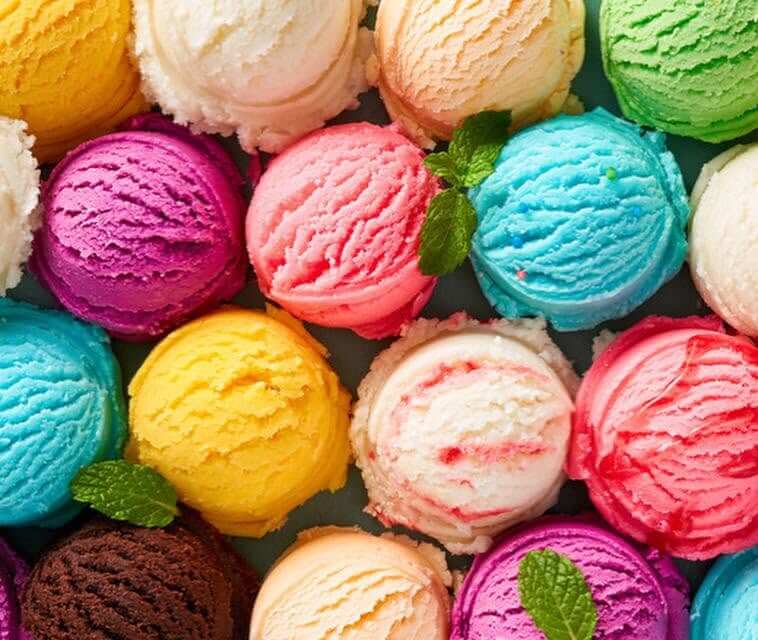 11 New Birmingham Restaurants to Try This Month - 12 Several colorful ice cream scoops arranged closely together, with a few mint leaves placed on top of some scoops.