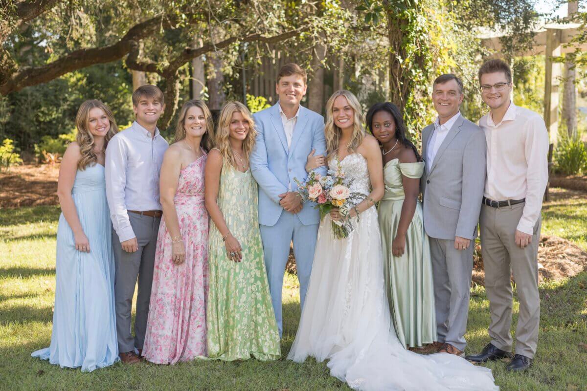 Meet the Woman Behind Muddy's Bake Shop's Next Chapter - 5 A wedding party surrounding a bride and groom.