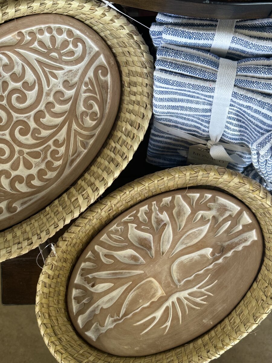 A bread warmer next to striped cloth napkins.