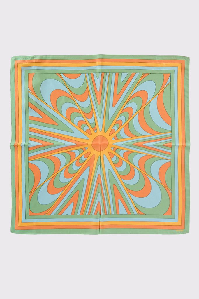 A square scarf with a colorful, symmetrical geometric pattern in orange, green, yellow, and blue, radiating outward from a central point and bordered by multicolored stripes.