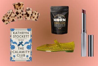Hair clips, a book titled The Calamity Club, loose leaf black tea, a yellow shoe, and a tube of lipstick.