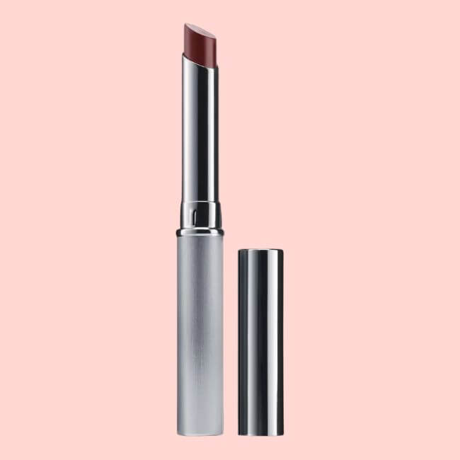 A silver tube of lipstick with the cap removed, showing a slanted mauve tip, set against a light pink background—featured on the SB Hot List for July 2026.