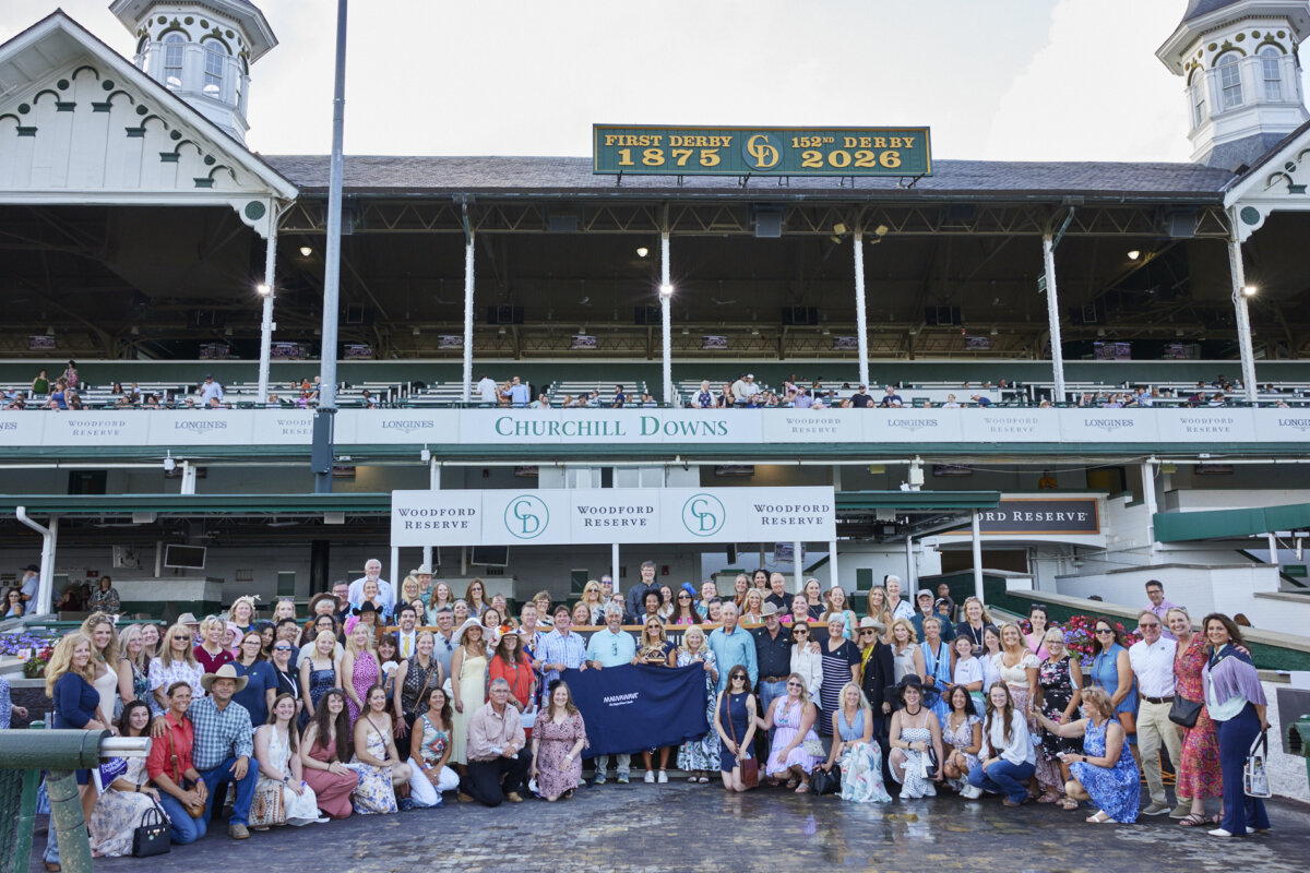 From TV Producer to Wellness CEO: Meet the Woman Revolutionizing Recovery - 5 A large group, including inspiring women in tech, poses outside Churchill Downs, beneath a sign noting the first Derby in 1875 and the 150th Derby in 2024.