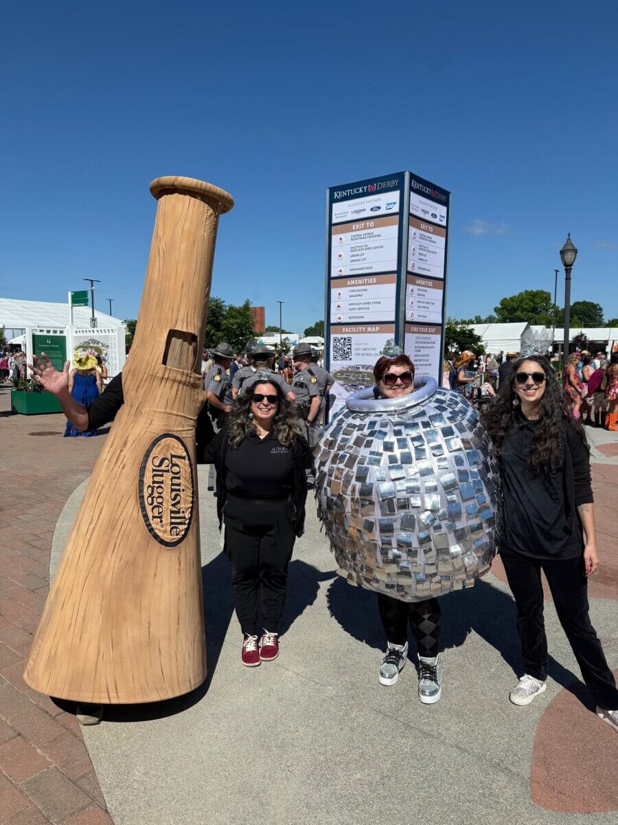 Meet the Creative Visionary Behind Actors Theatre of Louisville - 5 Four people stand outside at an event, one in a baseball bat costume, one in a mirror ball costume, and two in black outfits.