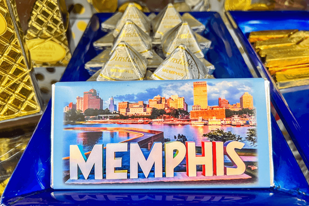 20 Memphis FINDS to See You Through the End of Summer - 15 A Memphis souvenir chocolate bar featuring a city skyline photo sits among other chocolates in decorative packaging.