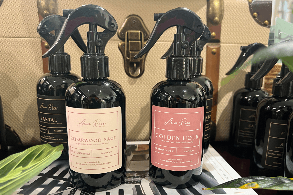 20 Memphis FINDS to See You Through the End of Summer - 5 Two bottles of room spray labeled "Cedarwood Sage" and "Golden Hour" are displayed on a surface, with more similar bottles and a beige textured bag in the background.