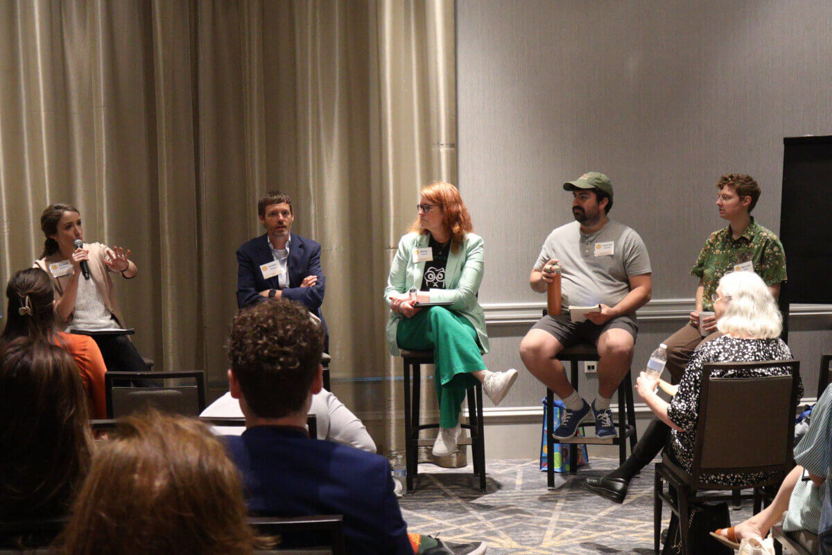 She’s Helping Put Books in the Hands of 500,000 Tennessee Kids - 8 Five people sit on chairs at the front of a room speaking to an audience during a panel discussion. One woman on the left is holding a microphone and gesturing while others listen.