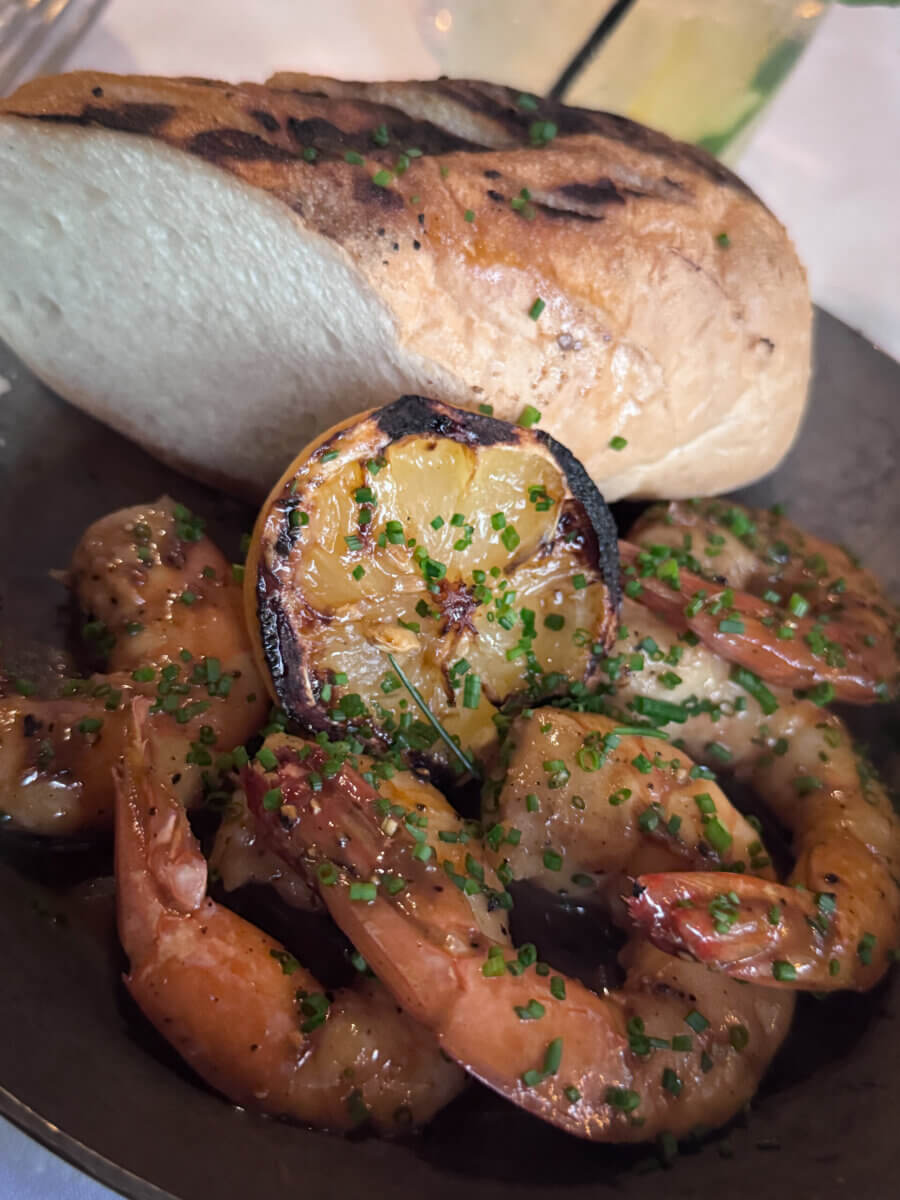 An Ode to Oxford: How to Eat Your Way Through This Delicious Small Town - 7 Grilled shrimp with herbs served with a slice of toasted bread and a charred lemon on a plate.