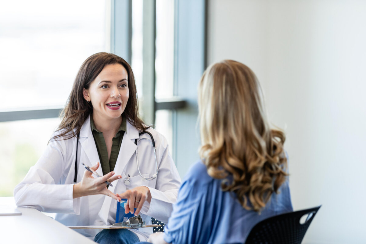 A doctor and patient, talking in an office.
