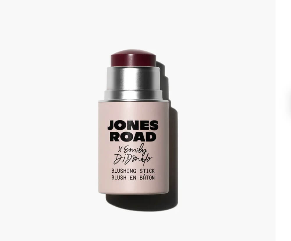 Bobbi Brown's Essential Makeup Musts for Every Decade - 9 A Jones Road blushing stick with a burgundy cap is shown upright on a white background.